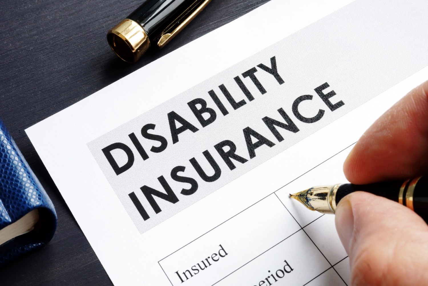 Man is filling in Disability insurance form. Individuals need disability insurance